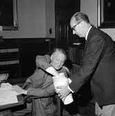 Lottdragning vid Centralförvaltningens sammanträde i plenisalen. Generaldirektör (Gd) Erik Upmark drar lott,
Avdelningsdirektör (Ad) Olofsson håller lotturnan.