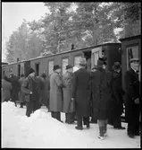 Resande går ombord personvagnar.