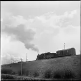 Ånglok med godsvagn.