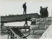 Arbetslag under anläggande av Inlandsbanans järnvägsbro.
Inlandsbanan påbörjades 1902 och invigdes i sin helhet 1937.
Fotot från SF-filmen Kronans Rallare.