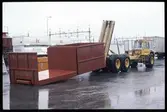 Lastbehållare lossas från en Volvo BM 860.