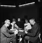 Bridgeklubben. Två kvinnor och två män vid tävlingsbord nummer fyra.