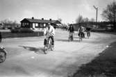 Arbetsdagen är över på CVA, Centrala Verkstaden Arboga. Männen cyklar hem med sina matväskor på styret. Mannen längst till vänster är Ingvar Söderberg. Bakom honom kommer Hans-Erik Larsson (