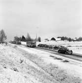 Örebrovägen öppnas efter ombyggnad
En personbil och fyra bussar kör på vägen. Flera tomma bilar står parkerade vid sidan av. Det är vinter och snö.