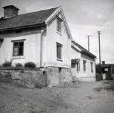 Vy från Figeholm, bostadshus med träpanel och sadeltak.