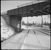 Viadukt över vintrigt järnvägsspår.