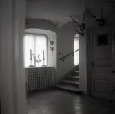 Hallinteriör med stengolv, trappa och valvfönster, i Västrum socken.