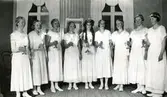 Lucia med tärnor i lilla salen i Kållereds Missionskyrka (idag: Ekenkyrkan) 1930-tal.
Från vänster: Ingeborg Johansson Andersson, Thelma Benkel Carlberg, Nellie Gustafsson Kullbring, Lisa Eriksson Jakobsson, Lucia: Rut Lind, Maj Engström, Ingrid Karlsson, Linnea Fredriksson Hindström, Maj Britt Pettersson Björkman.
