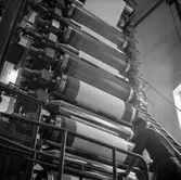 Åke Lundgren i arbete vid maskin på pappersbruket Papyrus i Mölndal, 6/5 1955.