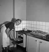 Rumsinteriör, bakning, en kvinna.
Fru Hellkvist
Konsum