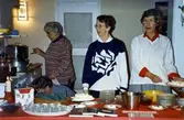 Julmarknad för Mölndals museum, Hemslöjdsföreningen och Studieförbundet Vuxenskolan i Stora Götafors 1979. Kållereds hembygdsgille har försäljning av äggost och glögg. Från vänster: Eivor Bjerrhede, Inga Brandin och Karin Gustafsson. Bakom bordet skymtar Berny Gustafsson.