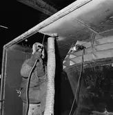 Svetsare i arbete å plastverkst.