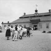 Folkdansuppvisning på gårdsplanen utanför Skogaholms herrgård, Skansen.
