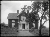 Kvinnor framför hus