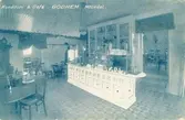 Interiörfotografi av Konditori och café Godhem vid Kvarnbygatan i Mölndals Kvarnby. Okänt årtal. Vykort tryckt i en blå nyans. Poststämplat i Kållered den 28/2 1927 till adressaten Fröken Ingeborg Gustavsson, Fridenslund Box 126 i Norrahammar.