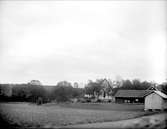 Landskapsvy med Lagga kyrka, Lagga socken, Uppland 1917