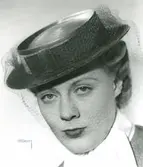 Fb, Porträtt av kvinna i hatt Madame Suzy. Stråhatt, grön balibuntal, grönt sammetsband, flor i rost.