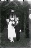 Bröllpsfoto av fotografens bror Ragnar Bengtsson med hustru framför en äreport.
