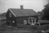Familjen Efraim Johansson i sin lite större kåltäppa framför bostadshuset på Kasen, Hogstorp, Skredsvik utanför Uddevalla i Bohuslän år 1924.
