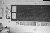 Svarta tavlan i ett klassrum. Dokumentation av Sagåsens flyktingförläggning, 1992.