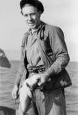 Rolf Andersson, API-arbetskamrat till Helmer Garthman, har fått en torsk. Näset, 1950-tal.