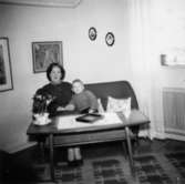 Familjen Garthmans vardagsrum i Mölndal, 1958. Astrid sitter i soffan med sonen Jerry.