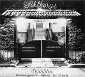 Vykort av Ahlbergs skrädderi på Barnhemsgatan 16. Man ser själva porten vid tomtgränsen mot gatan. Firmaskylt och reklam för Ahlbergs skrädderi. 1940-1960-tal.