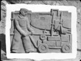 Relief med lastare vid flygplan av skulptören William Marklund