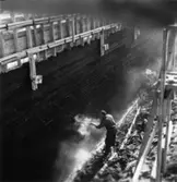 Byggnad N:o 6, tillbyggnad 1954. Isolering av grund.
En okänd man.