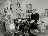 Trafikbiträdet J.L Larssons fru på 50 årsdagen.
Rumsinteriör, en kvinna.