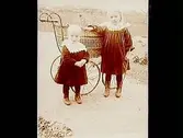 Två flickor och en barnvagn.
Gustaf Hedström
