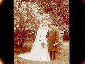 Brudpar, bruden helt i vitt, med krona, brudgummen i frack och hög hatt.
E. Alkman