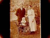 Familj, 3 personer, lilla flickan sitter i barnvagn.
Karl Gustafsson