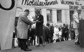 Knytkalaset 5 juli 1965.

Harald Aronsson står på scenen och mottar en prispropeller ur värdinnans hand. Publik i bakgrunden. 
Herre håller tal.