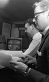 Pensionärspop 2 mars 1966

Två herrar i ett rum. Mannen i förgrunden bär mörk kostym och glasögon. Mannen längre bort i bilden har vit skjorta. En TV-apparat och teknisk utrustning syns i bakgrunden. De befinner sig i ett kontrollrum.