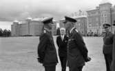 Kungen I3 28 augusti 1967

Kung Gustav VI Adolf besöker Örebro Livregementes Grenadjärer i Grenadjärsstaden. Ett antal män står uppställlda på regementsgården klädda i militäruniformer liksom kungen. Den sistnämnde står och samtalar med en general. En man i svart kostym, vit skjorta och ljus slips syns i bakgrunden.
