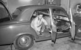 Görtz motor (Rep av oil) 6 april 1967

En man som befinner sig i en bilverkstad sitter på huk på golvet i baksätet på en bil som har alla dörrar samt bagageluckan öppen. Han är i färd med att dra loss golvmattan i bilen. Han är klädd i vita arbetskläder samt har en mörk keps på huvudet.