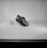 En sko.
Oscaria Skofabrik.