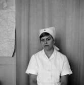 En sjuksköterska, bröstbild.
Bilden tagen för pass.