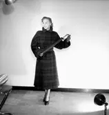 En kvinna.
Damkonfektion från Konsum.