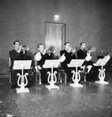 Whispering Band, fyra män med musikinstrument.