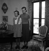 Rumsinteriör, en kvinna och en flicka.Elof Larsson