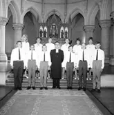 Interiör av Olaus Petrikryka, konfirmation, sex flickor, sex pojkar och en präst.