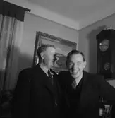 Rumsinteriör, två män.
Lind och Fritz.
Linds 60-årsdag.