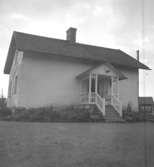 Stenhus i Skråmmen. Det kan vara Skråmmens gamla skola som skymtar i bakgrunden.

14 augusti 1956.