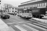 Trafik på Gamla Riksvägen i Kållered, år 1984. På högra sidan vägen ses närmast Posthuset, Gamla Riksvägen 48.

Fotografi taget av Harry Moum, HUM, Mölndals-Posten, vecka 4, år 1984.

Bildtext:
