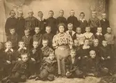 Skolklass, ateljebild, 1908, Sigrid Larsson, övre raden från vänster: Fritjof Jönsson, Oscar Rosvall, Ivan Norrman, Edvin Lundberg, Thure Rickt, okänd, Erik Karlsson, Lave Österling, Sven Svensson, Karl Jönsson,  2:a raden: O Gullstrand, Sigfrid Jönsson, Gösta Borg, Hilding Wall, Fröken S Larsson (Sigrid?), Erik Larsson Ekelund, Erik Kjellberg, Mårtensson, Erik Simonsen, Erik Green, 3:e raden okänd, Ernst Rydberg, Erik Persson, Ruben Lindkvist, Albin Örström, G Carlsson, I Månsson, Gunnar Möller, 4:e raden Olof Mellander, okänd, Åke Malmros, Åke Holmberg.