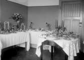 Skolköksuppvisning, tre fina dukade bord med blommor, mat och annat 1931	metallutfällning, fingeravtryck, lätta repor.