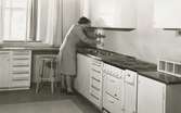Köksutbildning kvinna i köket som tar vatten