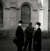 Två präster med elvor som prästkrage och en man utan prästkrage.